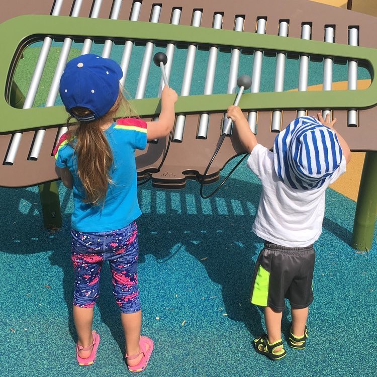 Two children playing a xylophone in the play area at Riverside Park. Photo by @jenncubby on Instagram.